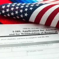 Application for asylum to USA concept with application form and USA flag on mexican serape