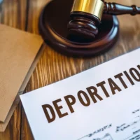 a-wooden-gavel-rests-beside-a-document-labeled-deportation-on-a-table