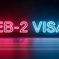 neon-sign-reading-eb2-visa-in-red-and-blue-glows-above-a-reflective-u