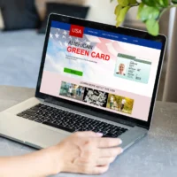person-uses-laptop-showing-an-american-green-card-application-webpage