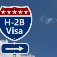 road-sign-resembling-a-highway-shield-reads-h2b-visa-with-stars-above